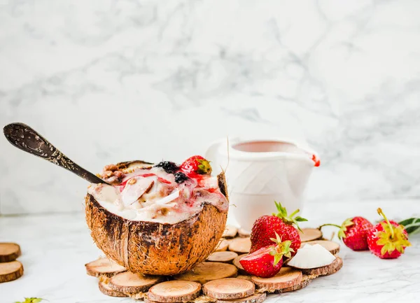 Smoothie aux baies avec beurre d'arachide et sauce aux fraises dans un coco — Photo