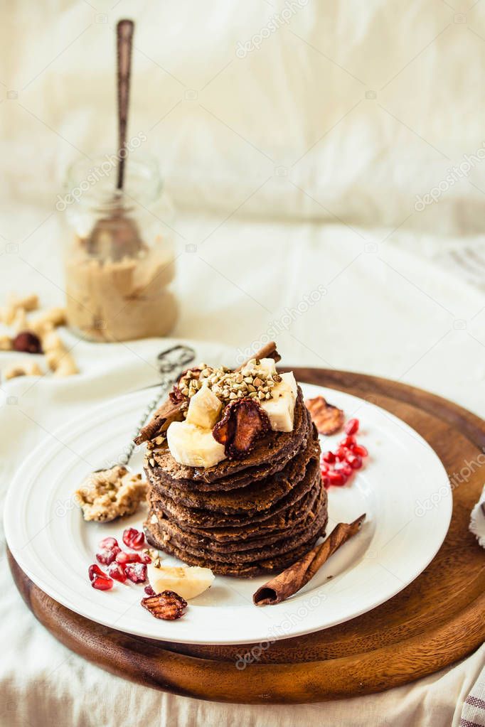 Chocolate pancakes with banana, peanut butter, cinnamon and mapl