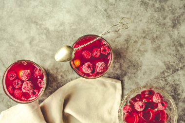 Berries in jelly pudding with fresh raspberries in glasses. Vale