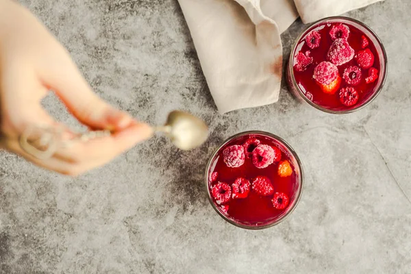 Young woman hands holding and eating sweet fruit jelly marmalade — ストック写真