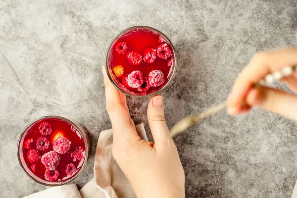 Young woman hands holding and eating sweet fruit jelly marmalade — Stockfoto