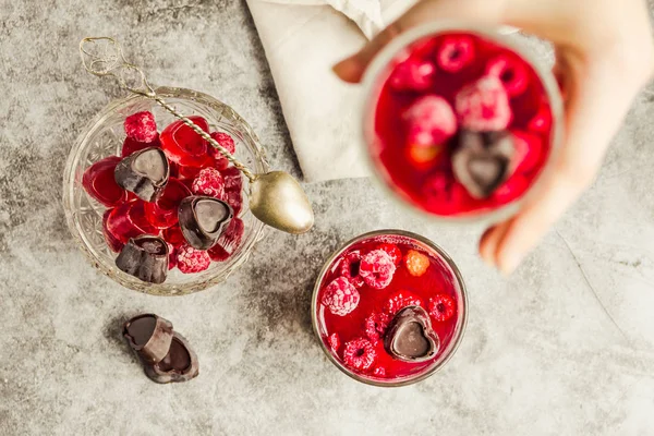 Young woman hands holding Sweet cold red jelly with berries and — ストック写真