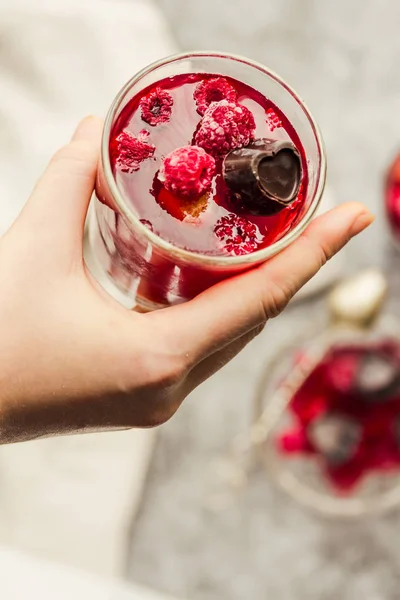 Young woman hands holding Sweet cold red jelly with berries and — Stok fotoğraf