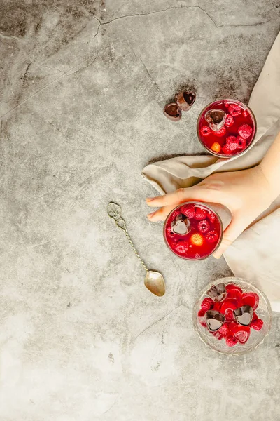 Young woman hands holding Sweet cold red jelly with berries and — Stock Photo, Image