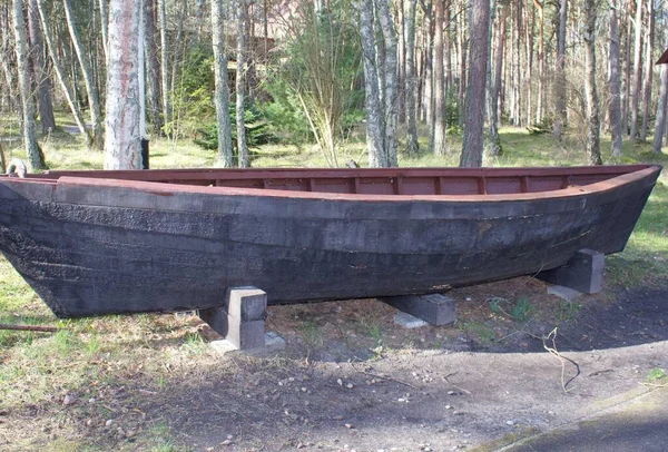 Part of old fishing boat covered  black color