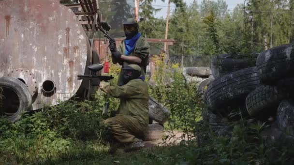 Man Playing Paintball Surrounded Tires — Stock Video