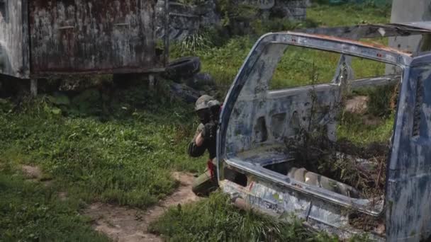 Man Playing Paintball Surrounded Tires — Stock Video