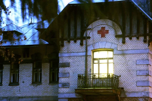 Yellow window in the old mansion of the old hospital