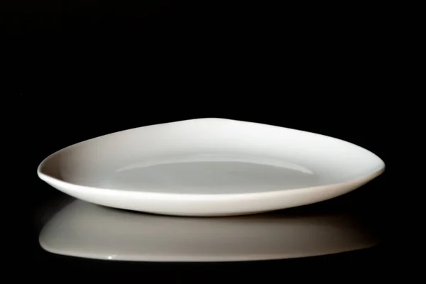 Empty white dinner plate on black background — Stock Photo, Image