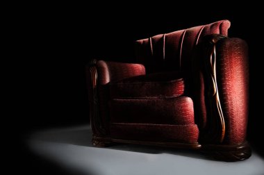 Siyah arka planda dramatik kırmızı kol koltuğu