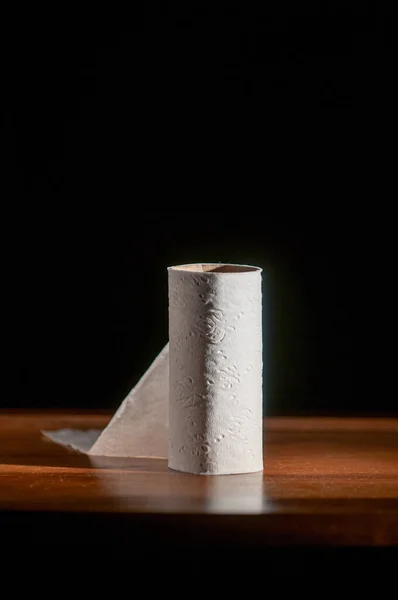 Single toilet paper roll on black background — Stock Photo, Image