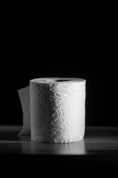 Single toilet paper roll on black background — Stock Photo, Image