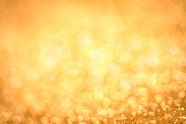 Gold Festive Christmas background. Abstract twinkled bright background with bokeh defocused golden lights