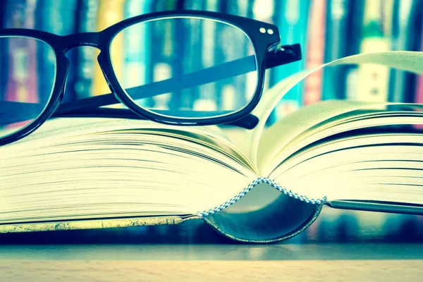 Close up opened book page and  reading eyeglasses — Stock Photo, Image