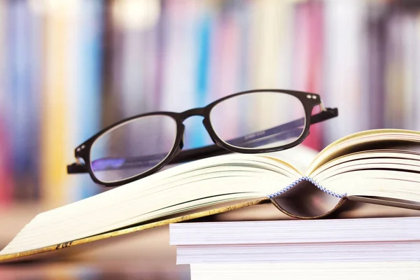 Close up opened book page and  reading eyeglasses — Stock Photo, Image