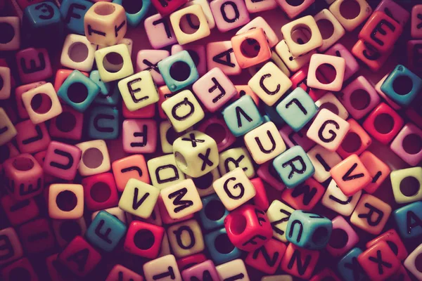 English alphabet cube as background, retro color tone — Stock Photo, Image