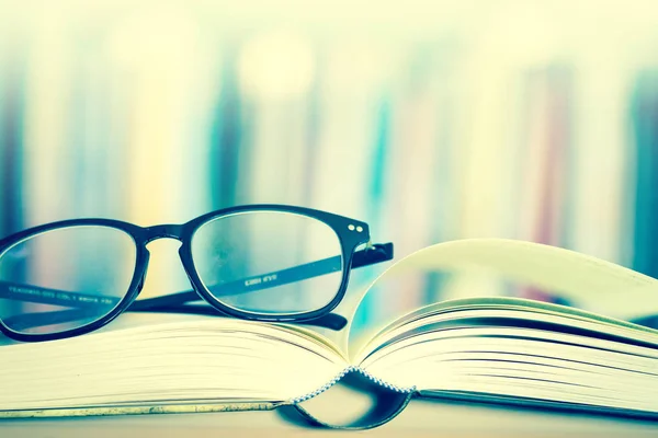 Close up opened book page and  reading eyeglasses — Stock Photo, Image
