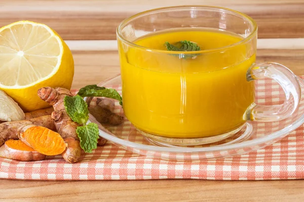 a cup of Turmeric Tea with lemon and ginger , Benefits for reduc