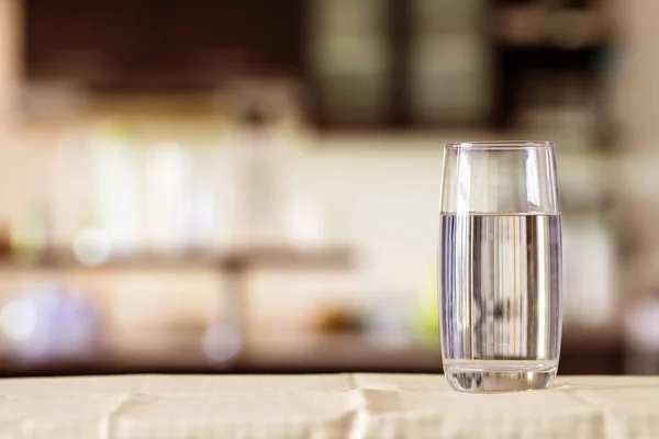 Склянку очищеної води на столі барі в кухні — стокове фото