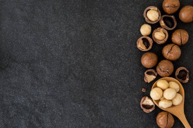 Macadamia fıstığı koyu siyah taş zemin üzerine kapatın ,