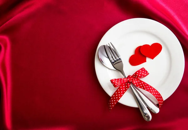 The Red Heart shape in White empty plate with fork and spoon on — Stock Photo, Image