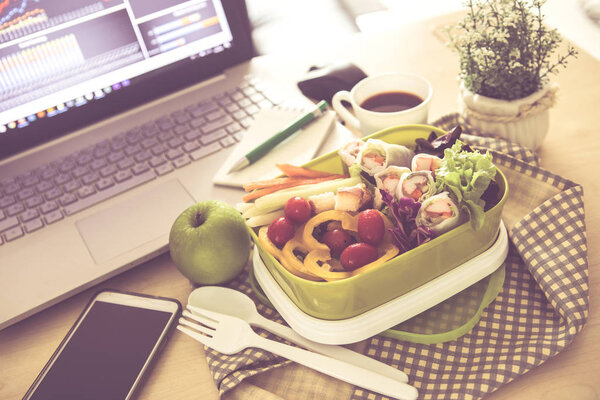 Close up green Lunch box on the work place of working desk ,Heal