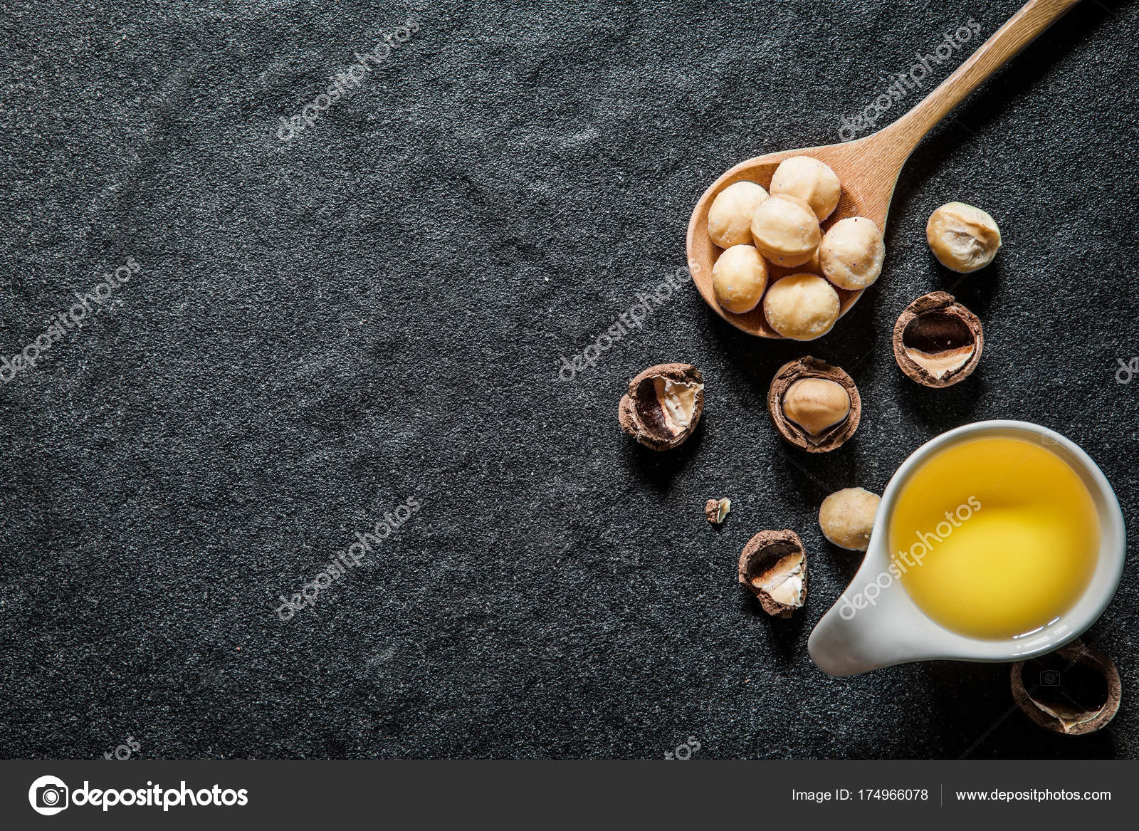 Macadamia Nut Oil And Peeled Macadamia Nut On Black Stone