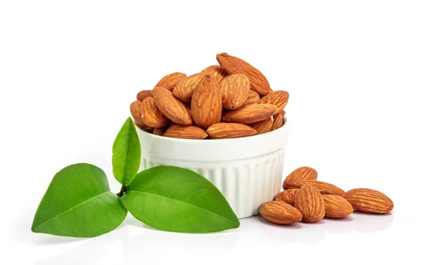 The fresh almonds in white cup on white background — Stock Photo, Image