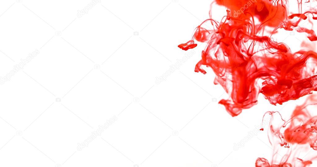 Close up red colored drop in  water , abstract motion movement o