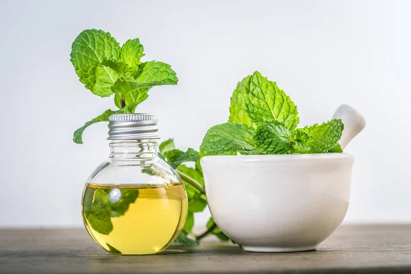 Aroma essential oil from a peppermint in the bottle on the table — Stock Photo, Image