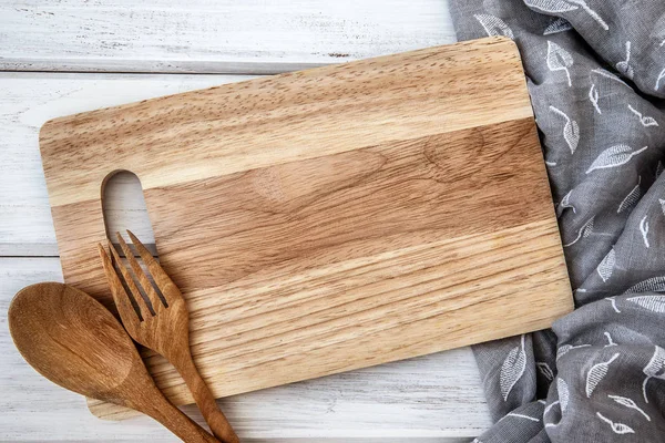 chopping board and tablecloth with the wooden fork and spoon on