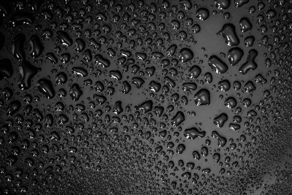 La goccia d'acqua astratta su superficie di sfondo nero fresco — Foto Stock