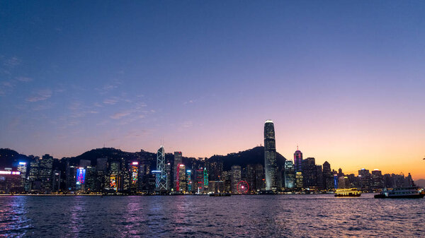 One international finance center surrounded by another tall buildings in Victoria Harbor at night, Hong Kong