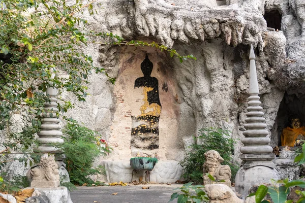 Buddha picture on the wall of man-made cave in Bangkok, Thailand