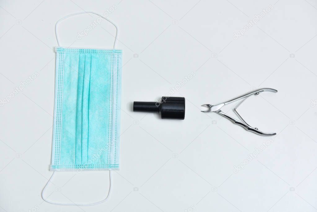 Gel polish, medical mask, manicure scissors, nail file, coronavirus equipment concept. Collage manicure set with coronavirus, 2019-nCoV. Gel polish equipments and coronavirus, COVID-19, 2019-nCoV.