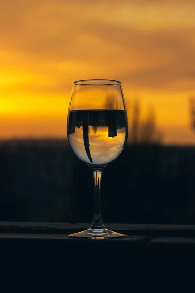 glass of water in the balcony in spring sunset