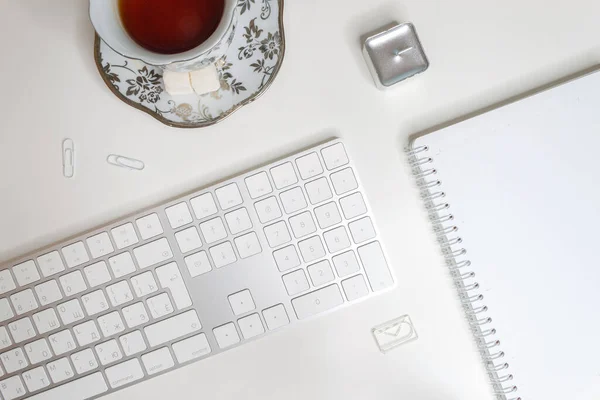 Flat Lay Workplace Blank Notepad Tea Cup Keyboard White Background — Stock Photo, Image