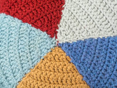Slices knitted from colored yarn. Beautiful handmade background. Closeup pillow