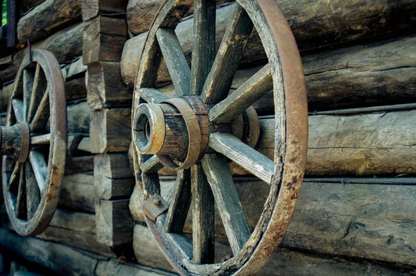 wooden wheels hang on a house
