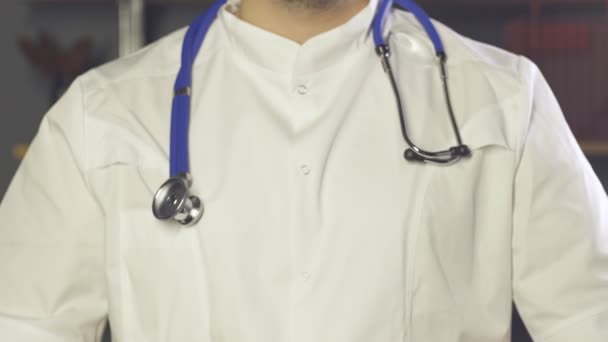 Close up of doctor with stethoscope showing heart gesture with his hands — 비디오