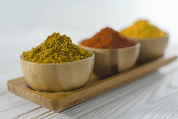 Close up of various spices in wooden bowls - turmeric, paprika, curry — Stock Photo, Image