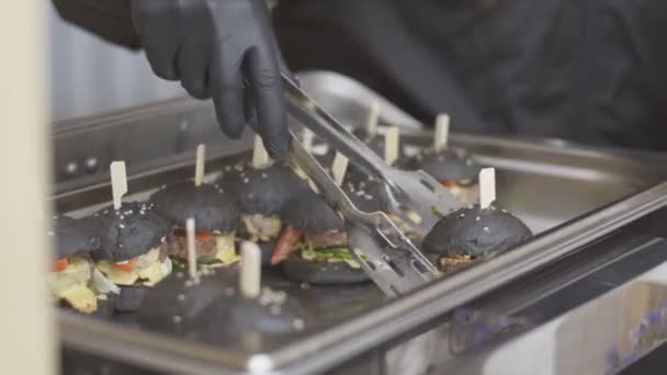 Close up of cook seller giving burger to customer at food truck - street sale — Stock Video