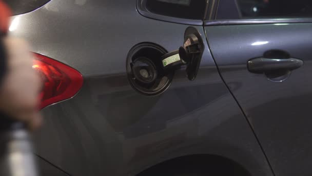 A man hand holding pump filling gasoline. Pumping petrol into the tank. — Stock Video