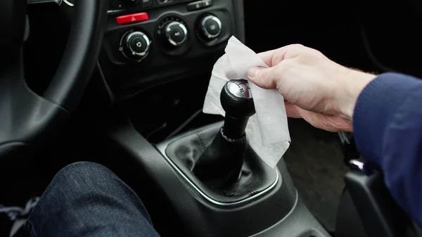 Hand disinfect the gear stick knob in the car against coronavirus epidemic outbreak. or Corona Virus Disease
