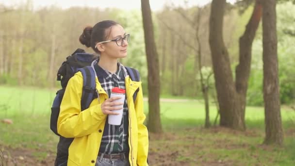 Young tourist woman holding thermos of hot drink, copy space. Travel and hiking concept — Stock Video