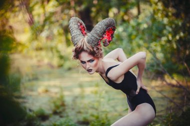 sexy beautiful woman with horns. Hairstyle.fantasy girl in woods clipart