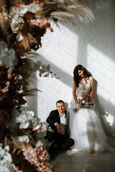 Novia Con Ramo Novio Sentado Suelo Fondo Del Arco Boda — Foto de Stock