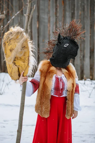 A man in a national costume with the head of an animal celebrates the arrival of the pagan holiday Maslenitsa. An ancient pagan rite