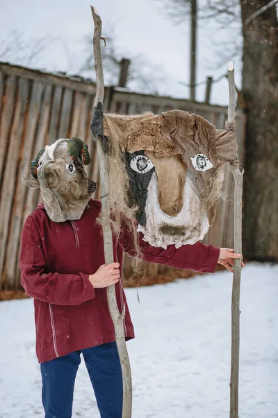 A man in a national costume with the head of an animal celebrates the arrival of the pagan holiday Maslenitsa. An ancient pagan rite