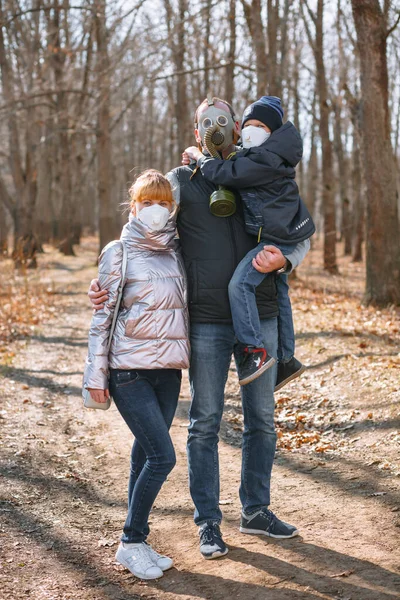 A small family in sanitary masks on a walk in the Park. People walk in the conditions of the quarantine